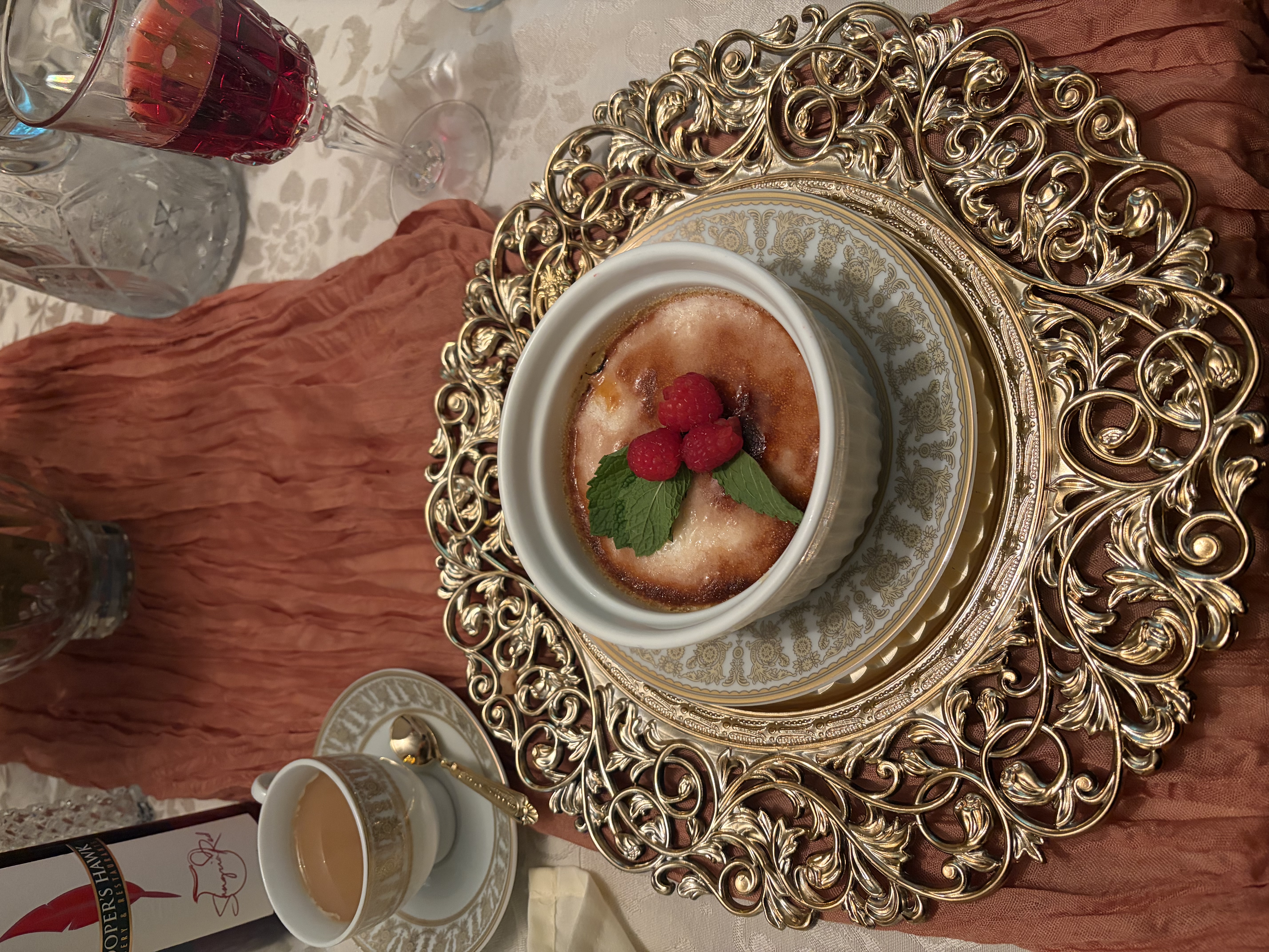 Crème brûlée with raspberries on gold filigree china for two