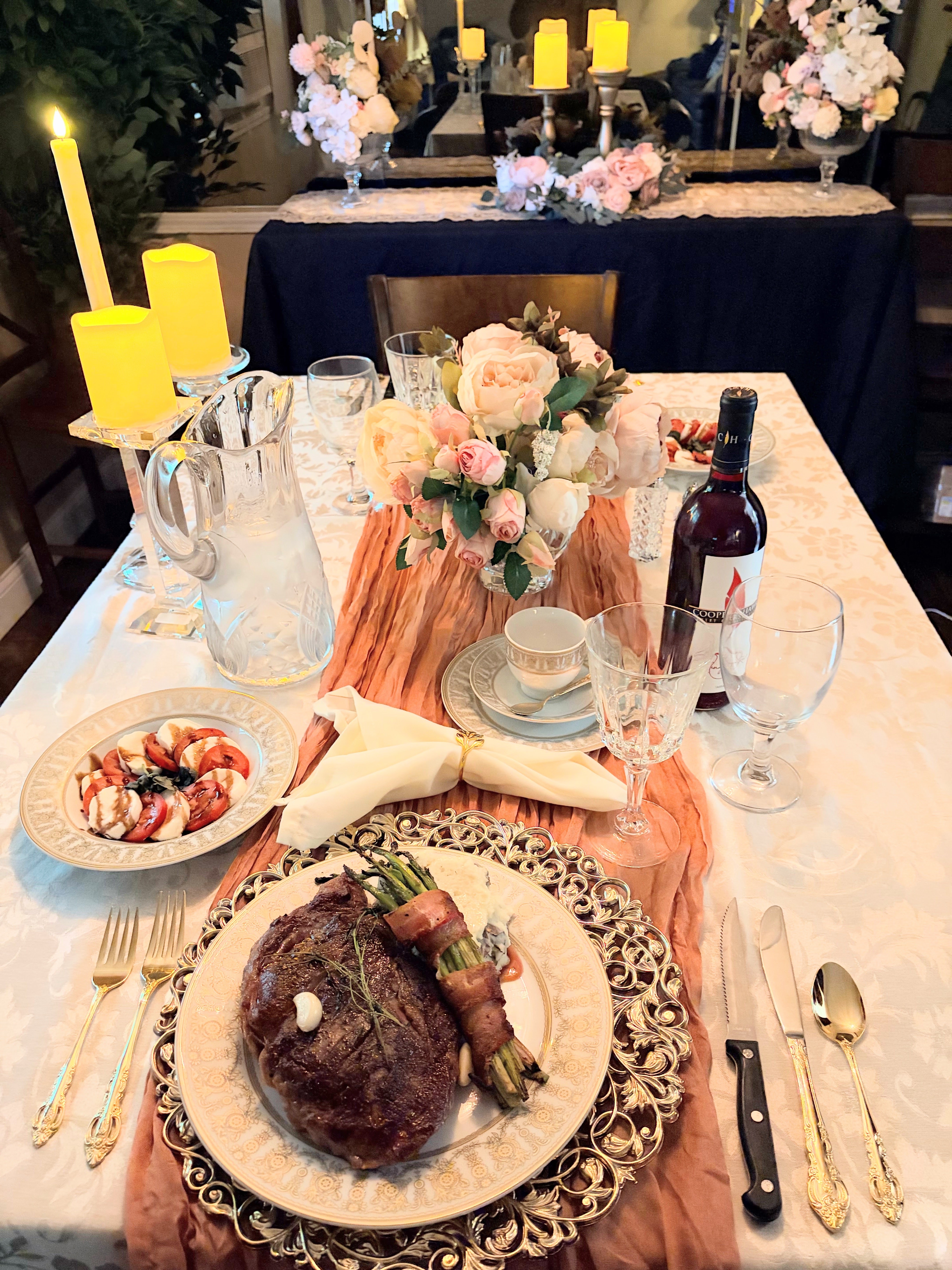 Intimate dinner for two with seared steak, Caprese salad, roses, and candlelight